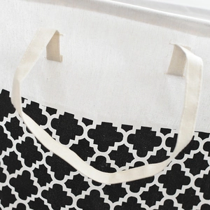 Detailed close-up of clover pattern fabric laundry basket with reinforced handle