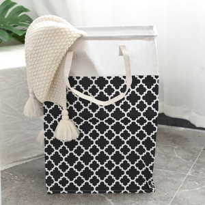 Detail of canvas laundry basket with clover pattern and sturdy reinforced handles