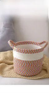 Close-up of bohemian woven cotton rope basket with colorful stripes and side handles