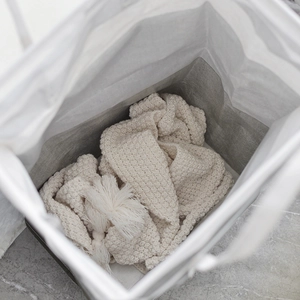 Large waterproof laundry basket with dual-layer fabric and soft knit blanket inside