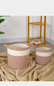 Detail of bohemian cotton rope baskets with multi-color weave and convenient side handles