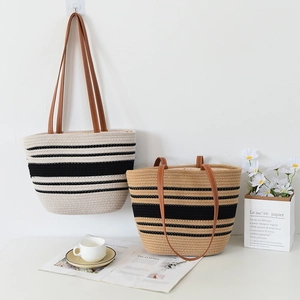 Close-up of woven striped tote bags in beige and khaki with brown leather handles
