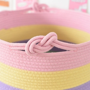 Dettaglio del manico a nodo in corda di cotone intrecciata su cesto portaoggetti rosa