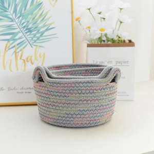Detailed close-up of handmade cotton rope storage baskets with cat ear handles