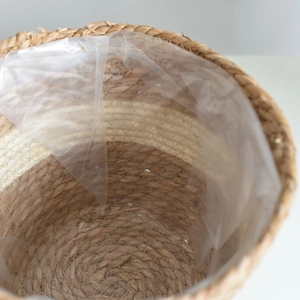 Handwoven cylindrical straw basket with waterproof liner for plants and storage