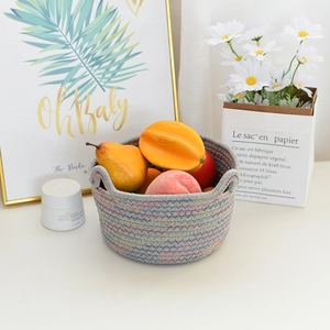 Detail of grey cotton rope basket with colorful zigzag stitching and side handles