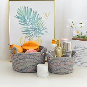 Two-piece grey woven cotton rope storage baskets with cat ear handles and zigzag stitching