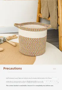 Detail of bohemian hand-woven cotton storage basket with handles and soft colorful textures