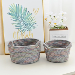 Detail of grey cotton rope woven baskets with colorful Z-shaped stitching and handles