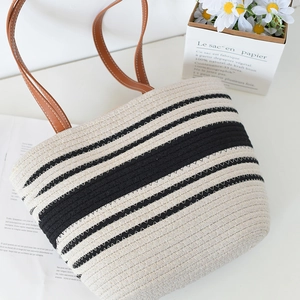 Fashionable woven tote bag with black and white stripes and brown leather handles