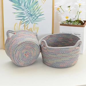 Set of grey woven cotton rope storage baskets with cat ears and colorful stitching