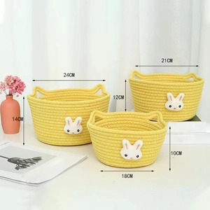 Three-piece yellow cotton rope storage baskets with cute bunny ears for desktop organizing
