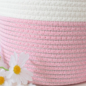 Dettaglio del cesto in cotone intrecciato con fibre bianche e rosa e fili metallici argento
