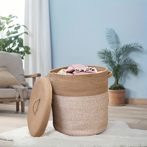 Detail of a large two-tone cotton rope laundry basket with a lid in a home setting