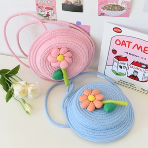 Détail du sac cabas rond tissé avec fleurs 3D et couleurs pastel de macaron