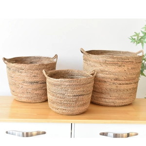 Set of three handcrafted woven grass planters with handles for Nordic home decor