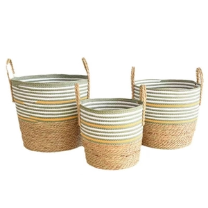 Three-piece set of woven seagrass plant baskets with colorful striped pattern and handles