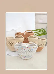 Detailed view of handmade woven bucket bags featuring wave patterns and pearl button closures