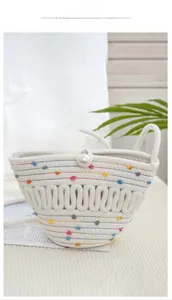 Detail of hand-woven white bucket bag with colorful dots and oversized pearl buckle