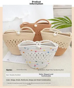 Detail view of woven bucket bag featuring pearl closure and dimensions of 15cm by 23cm