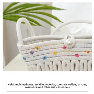 Detail view of woven bucket bag with colorful embroidered dots and pearl buckle closure