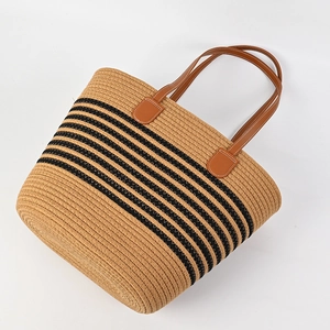 Striped woven straw tote bag with brown faux leather handles for summer vacations