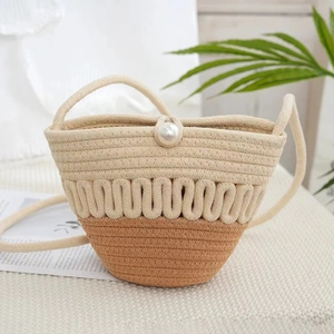 Handwoven bicolor mini bucket bag in cream and caramel brown with a pearl accent