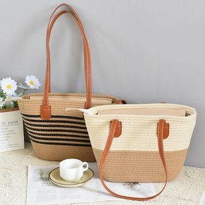 Detail view of woven straw tote bags with faux leather handles and zipper closure