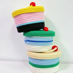 Three-piece colorful woven cotton rope storage baskets with lids and red bead handles