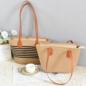 Large straw tote bag set with brown leather straps for summer beach vacations and travel