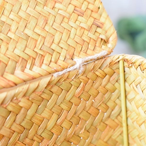 Macro shot showing the natural seagrass weaving texture and fiber rope hinge detail