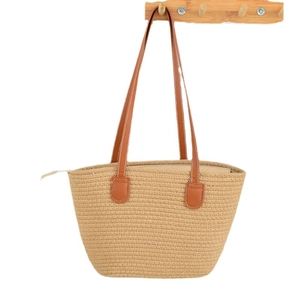 Large straw tote bag with brown leather handles and zipper closure for summer beach holiday