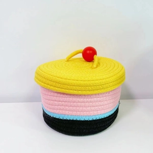 Close-up of a multi-colored woven cotton rope storage basket with a bright yellow lid