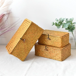 Detailed view of woven seagrass storage boxes set of 3 with wood button closure