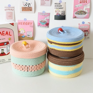 Close-up of cotton woven storage baskets with lids and colorful stripes for home decor