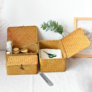 Detailed macro view of a set of three handmade seagrass storage baskets with lids