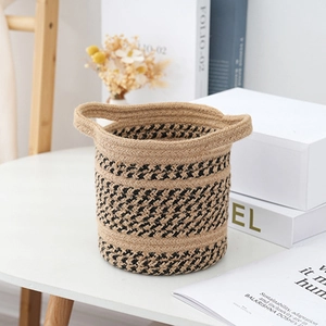 Detail of hand-woven cotton linen basket featuring dual handles and black diagonal patterns