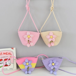 Detail of colorful woven mini bucket bags with cute 3D floral accents and rope straps