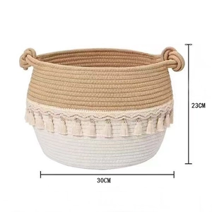 Detail showing handwoven cotton rope storage basket with decorative tassels and size markings