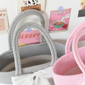Close-up of cotton rope woven striped handbag with large satin bow detail