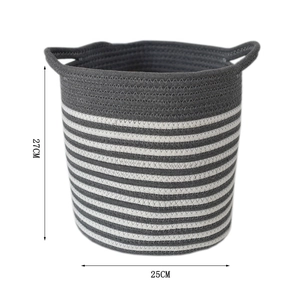 Detail of woven storage basket showing the gray and white striped texture and handle