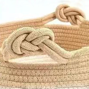 Detailed macro view of beige woven storage basket showing intricate rope texture and knots