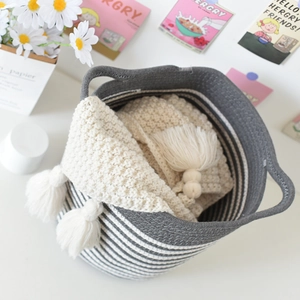 Japanese style woven cotton storage basket with grey stripes and fringe blanket detail
