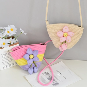 Detail view of woven cotton mini bucket bags with floral 3D decor and zipper closure