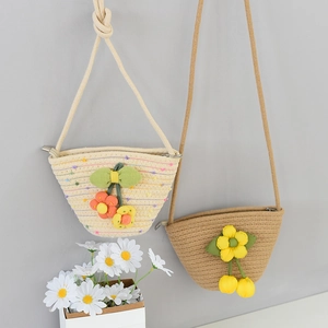 Detail of woven straw bucket bags with floral accents and secure zipper closures