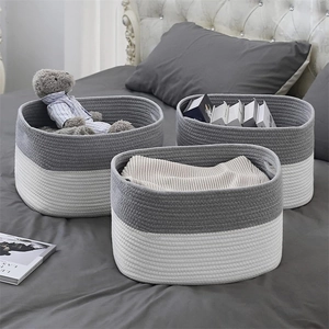 Detail of three-piece grey and white woven cotton rope baskets for home storage organization