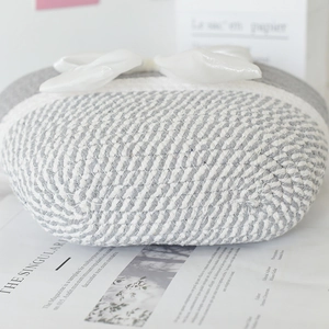 Close-up of the handcrafted honeycomb cotton weaving and large satin bow detail