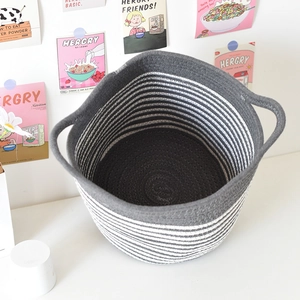 Detail of grey and white striped woven cotton rope basket with sturdy side handles