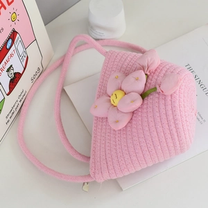 Detail of pink woven cotton bucket bag with large floral 3D decor and zipper closure