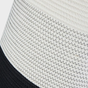 Detail of woven cotton storage basket showing zigzag stitching and dual-tone rope texture